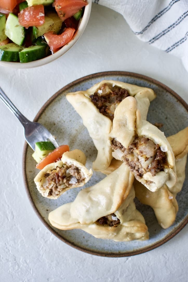 Joanna Gaines recipe for Jo's Fatayar with Lebanese Salad served on a plate with a bowl of the salad on the side. And the "dream bite" on a fork.