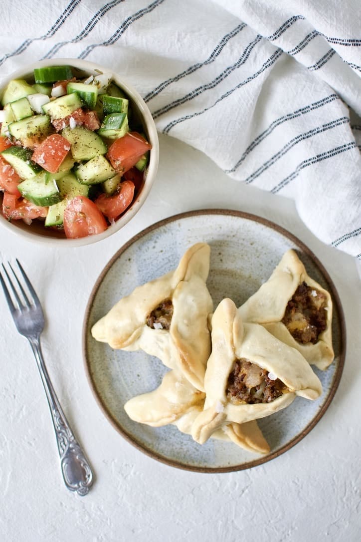 Joanna Gaines recipe for Jo's Fatayar with Lebanese Salad served on a plate with a bowl of the salad on the side.