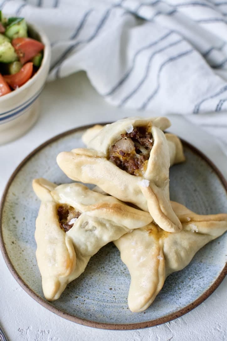 Joanna Gaines recipe for Jo's Fatayar with Lebanese Salad served on a plate with a bowl of the salad on the side.