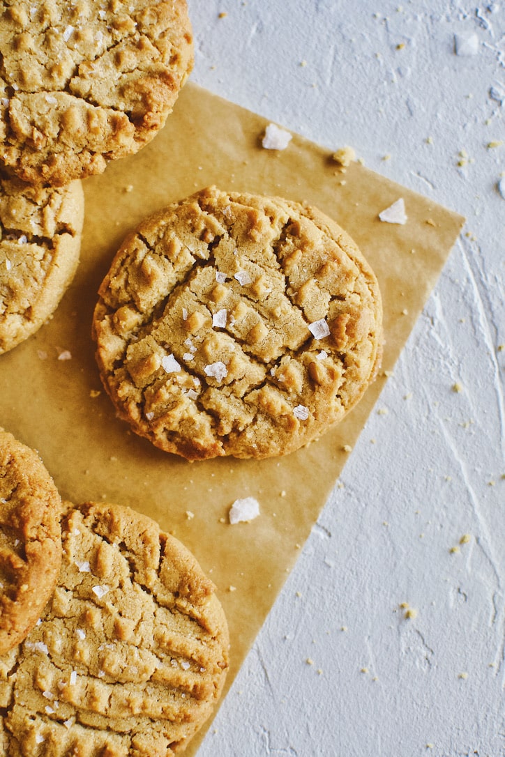 Crunchy Peanut Butter Cookies laid in a pile.