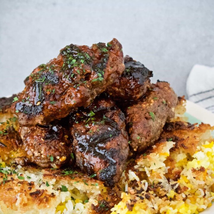 Long Kefta Meatballs on top of a bed of Tahdig Rice
