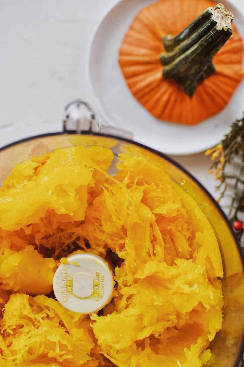 roasted pumpkin in the food processor bowl ready to be blended