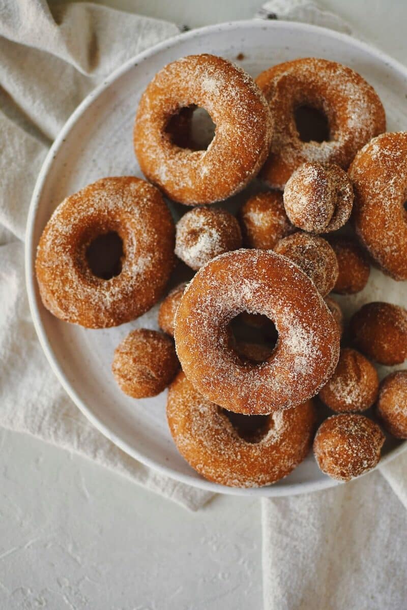 Pumpkin Donuts fresh out of the fryer and dusted in pumpkin spice sugar.