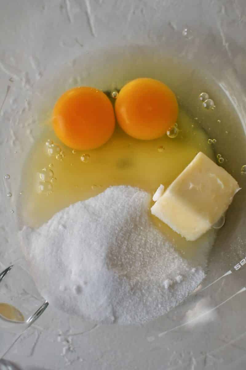 Starting the donut dough by whisking together the butter, sugar, and eggs.