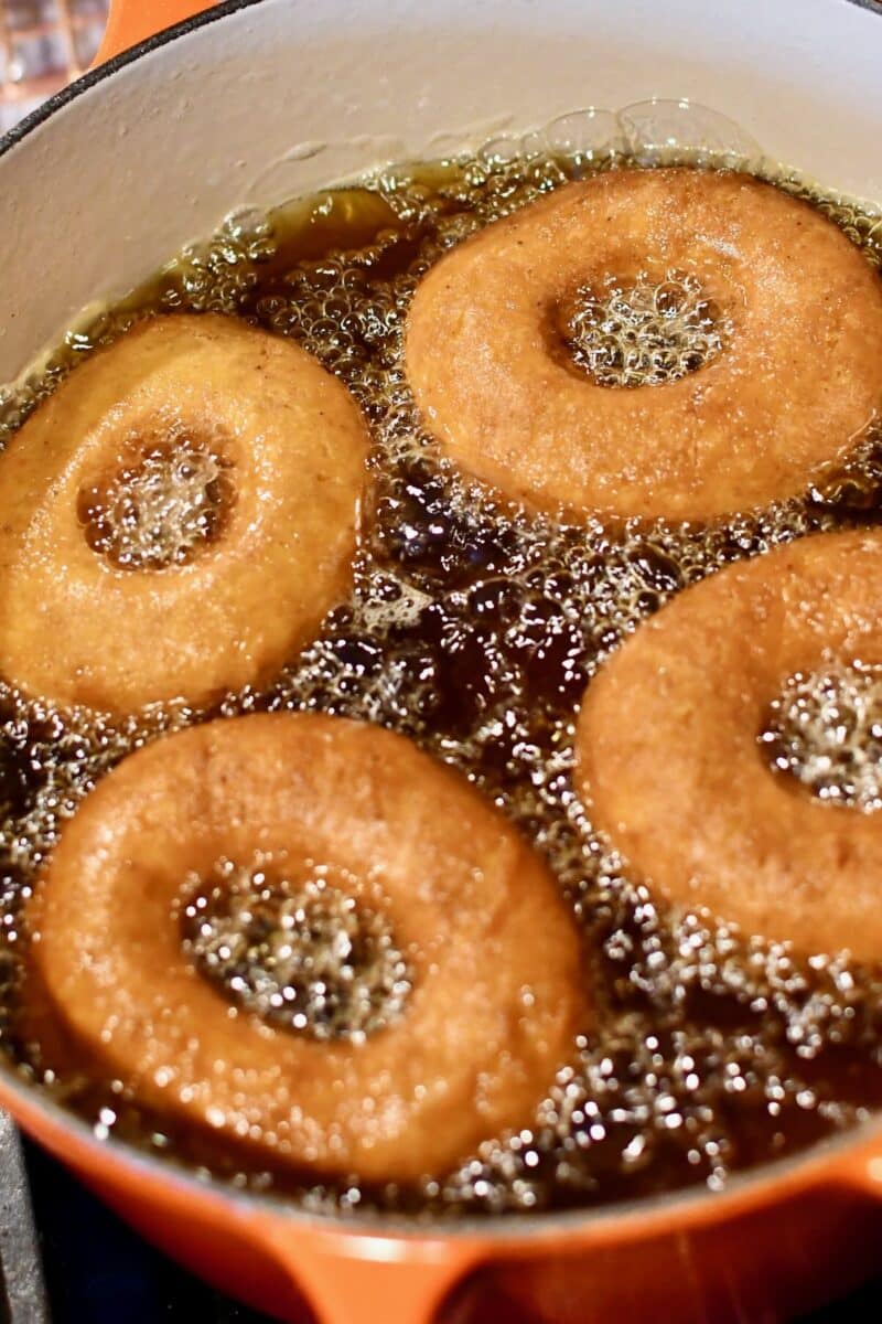 Donuts frying in hot oil.
