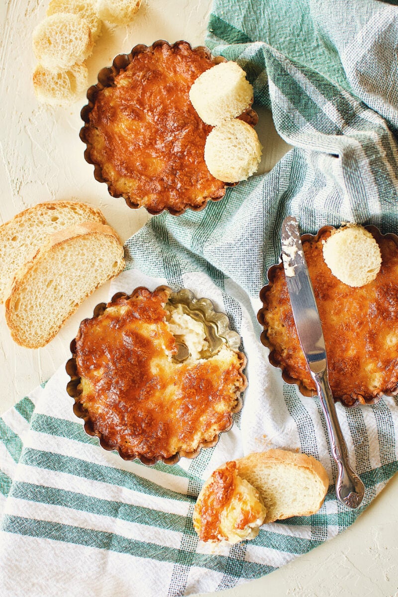 Artichoke Three Cheese Dip, with a little bit dished out on to a piece of toast.