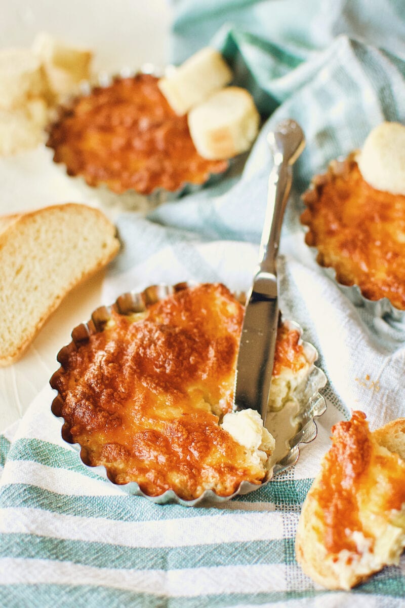 Artichoke Three Cheese Dip, with a little bit dished out on to a piece of toast.