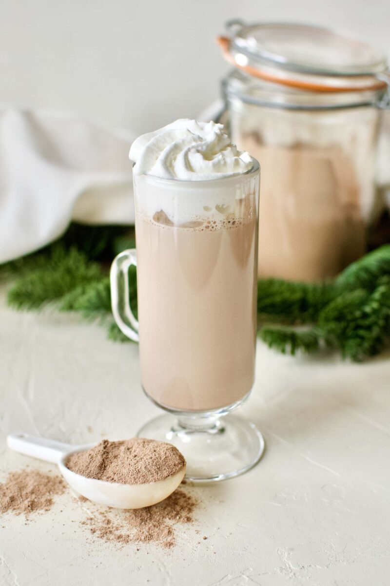 A glass of sugar-free hot cocoa topped with whipped cream.