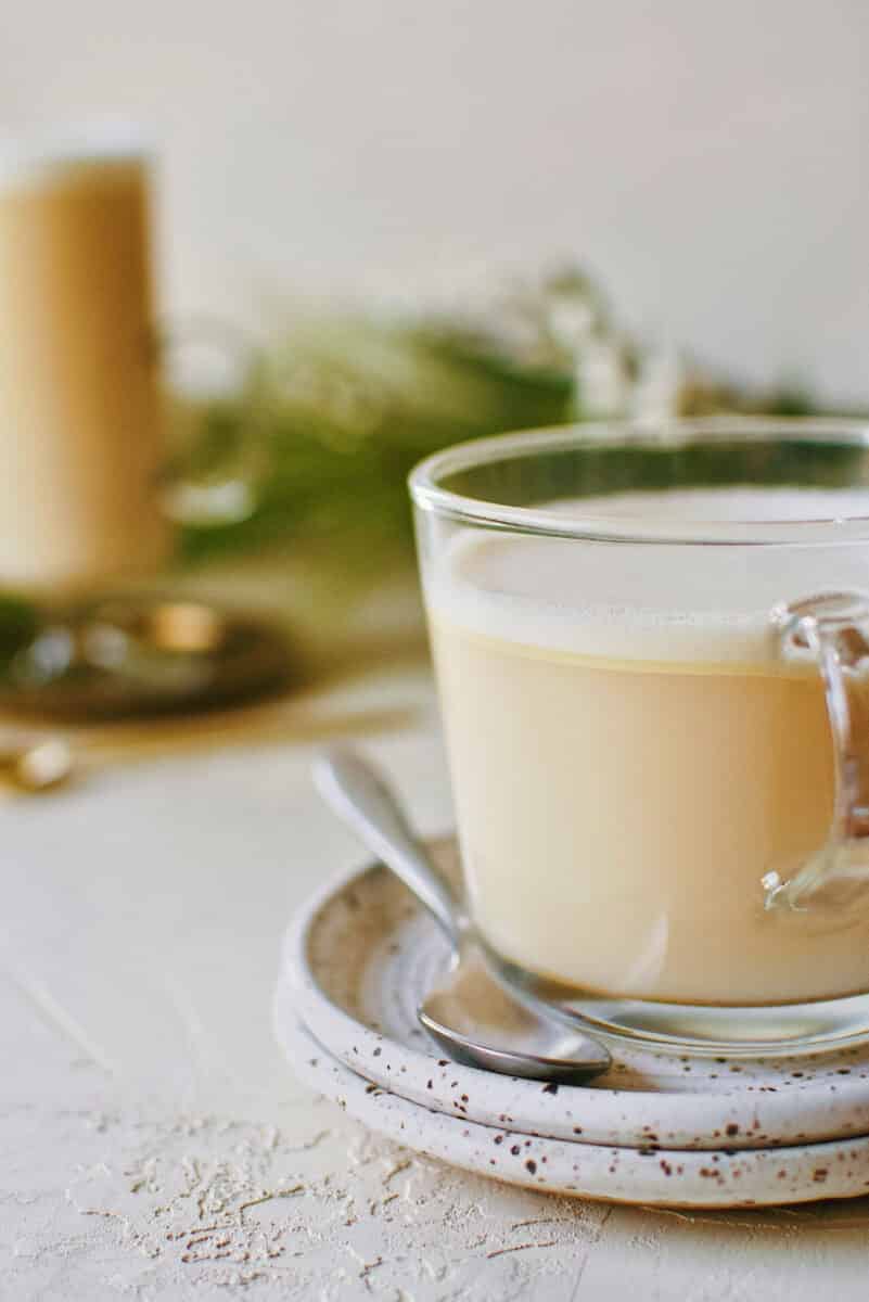 Hot buttered rum on a plate with a spoon.