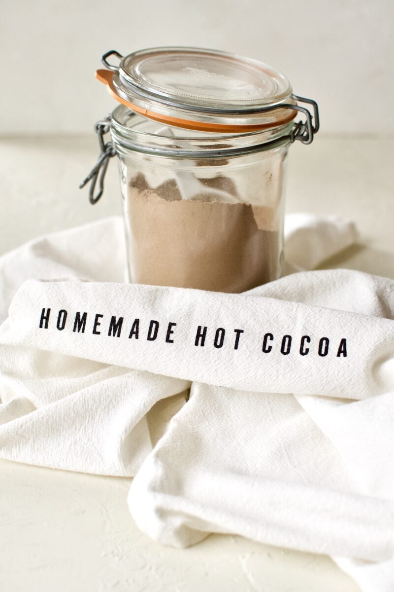 Sugar-Free Hot Cocoa Mix in a jar with a tea towel around it.