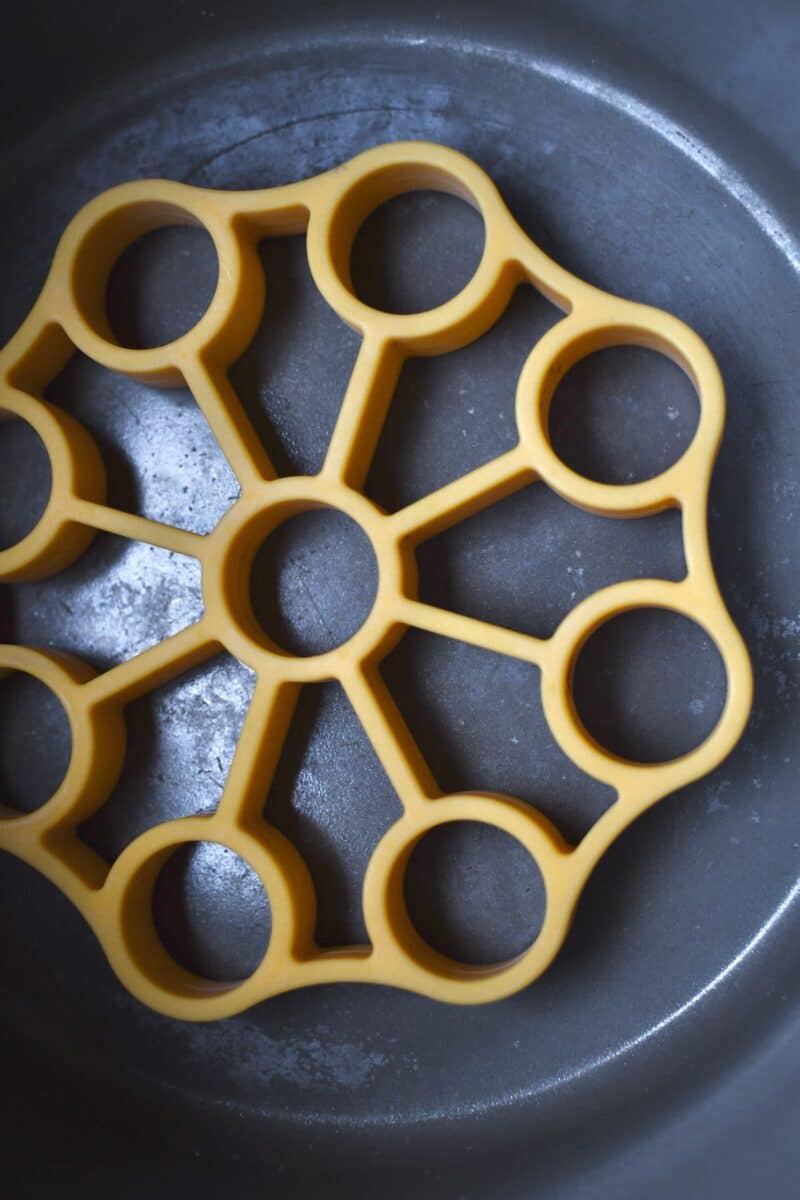 Lining the bowl of an instant pot with a silicone rack.