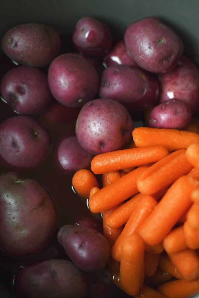 Red potatoes and carrots added to the instant pot after the corned beef has cooked.