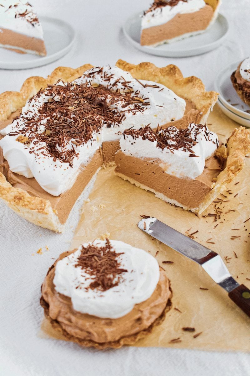 Joanna Gaines French Silk Pie that has been sliced, with tartlets around it