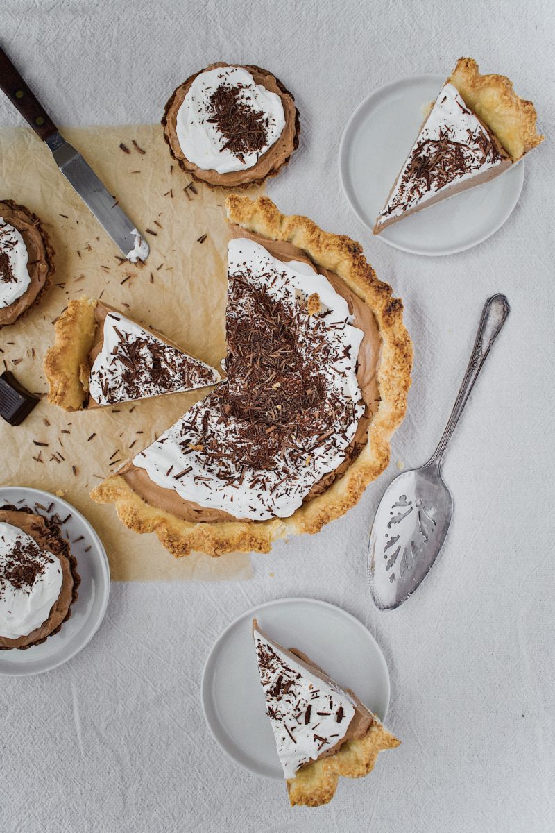 Joanna Gaines French Silk Pie that has been sliced, with tartlets around it