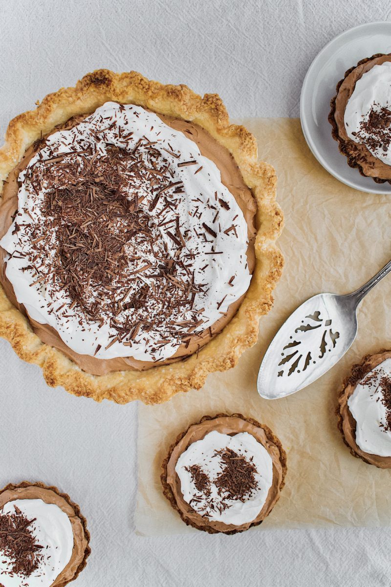 Joanna Gaines French Silk Pie that has been sliced, with tartlets around it