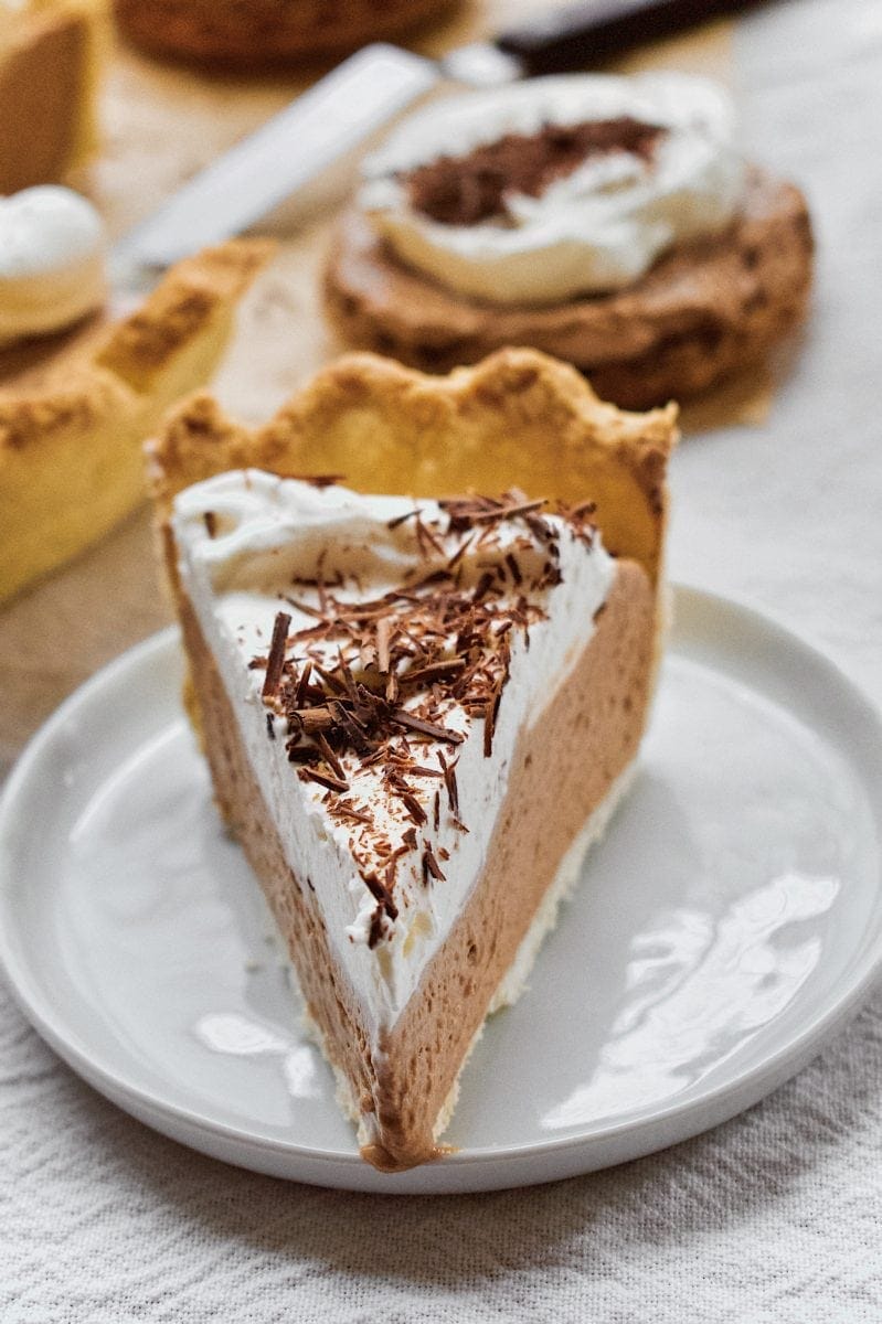 Joanna Gaines French Silk Pie that has been sliced, with tartlets around it