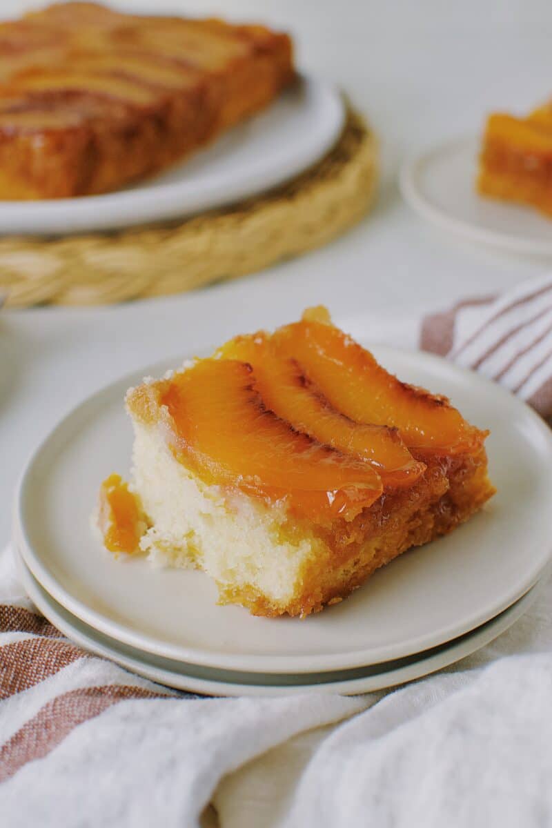 Peach Upside-Down Cake sliced on a plate.