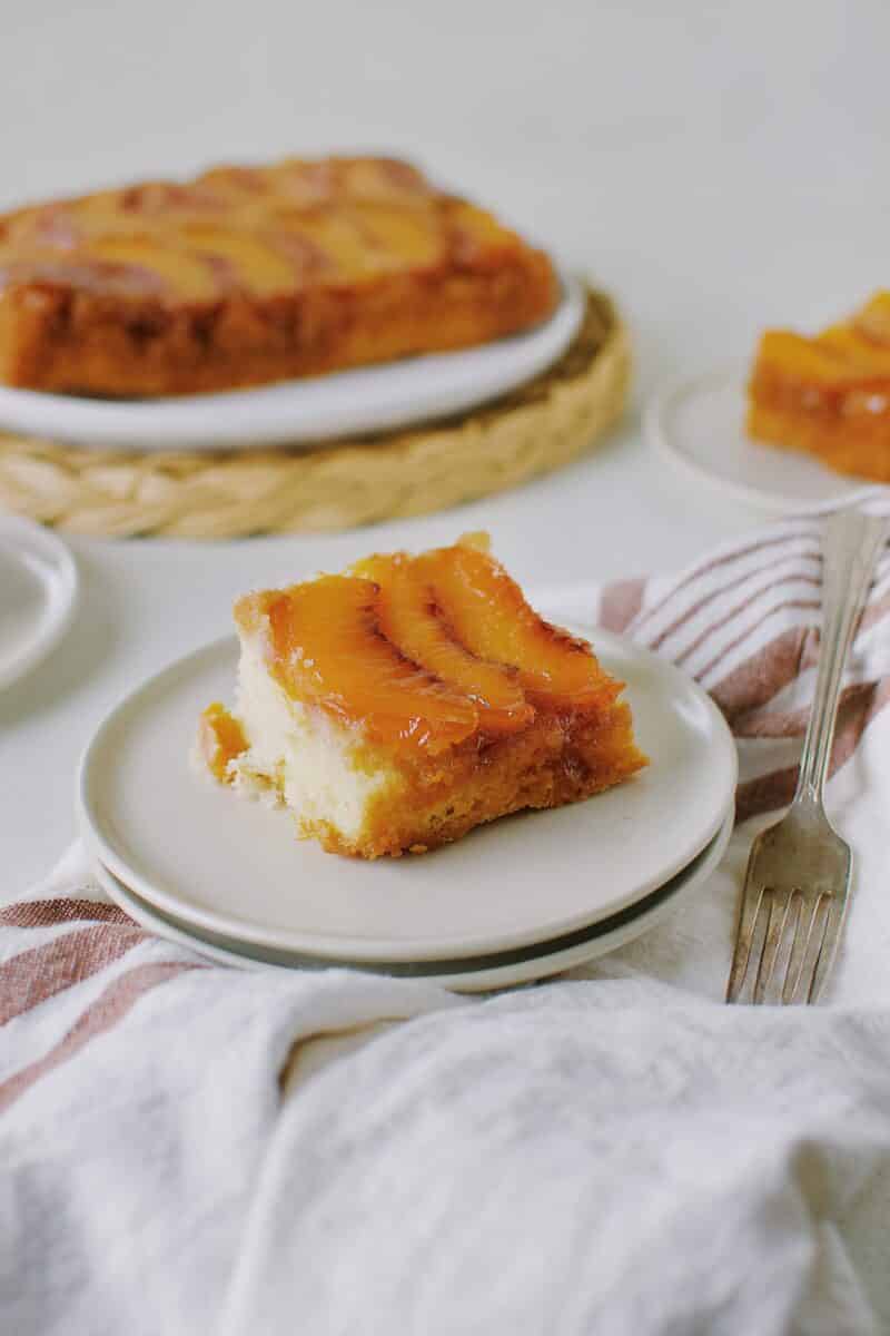 Peach Upside-Down Cake sliced on a plate.