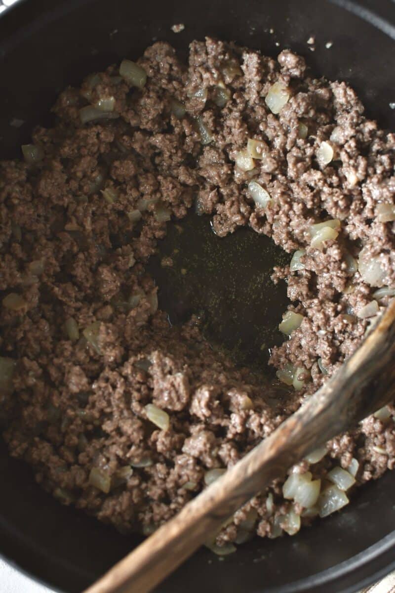 Browning the meat with the onions and cooking till the pan is nearly dry.