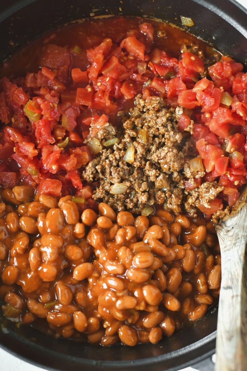 Wet ingredients and beans added to the browned meat in the stock pot.