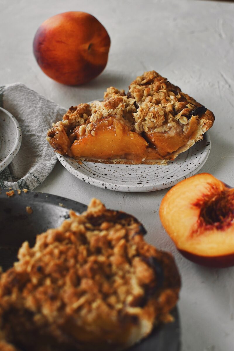 Looking at the side of a slice of spiced peach pie.