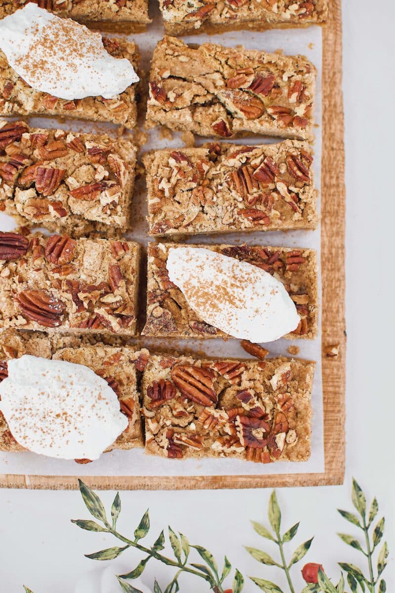 Pumpkin Dessert Bars cut and topped with whipped cream