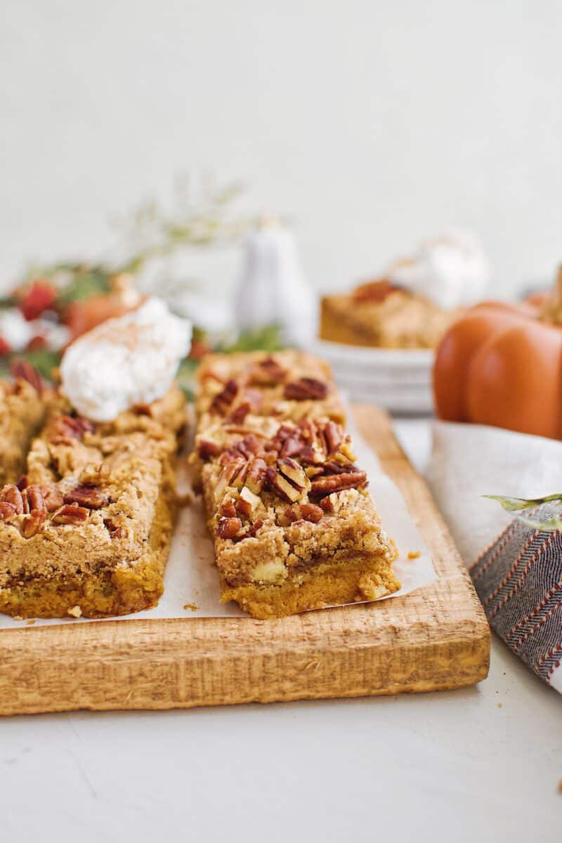 Pumpkin Dessert Bars cut and topped with whipped cream