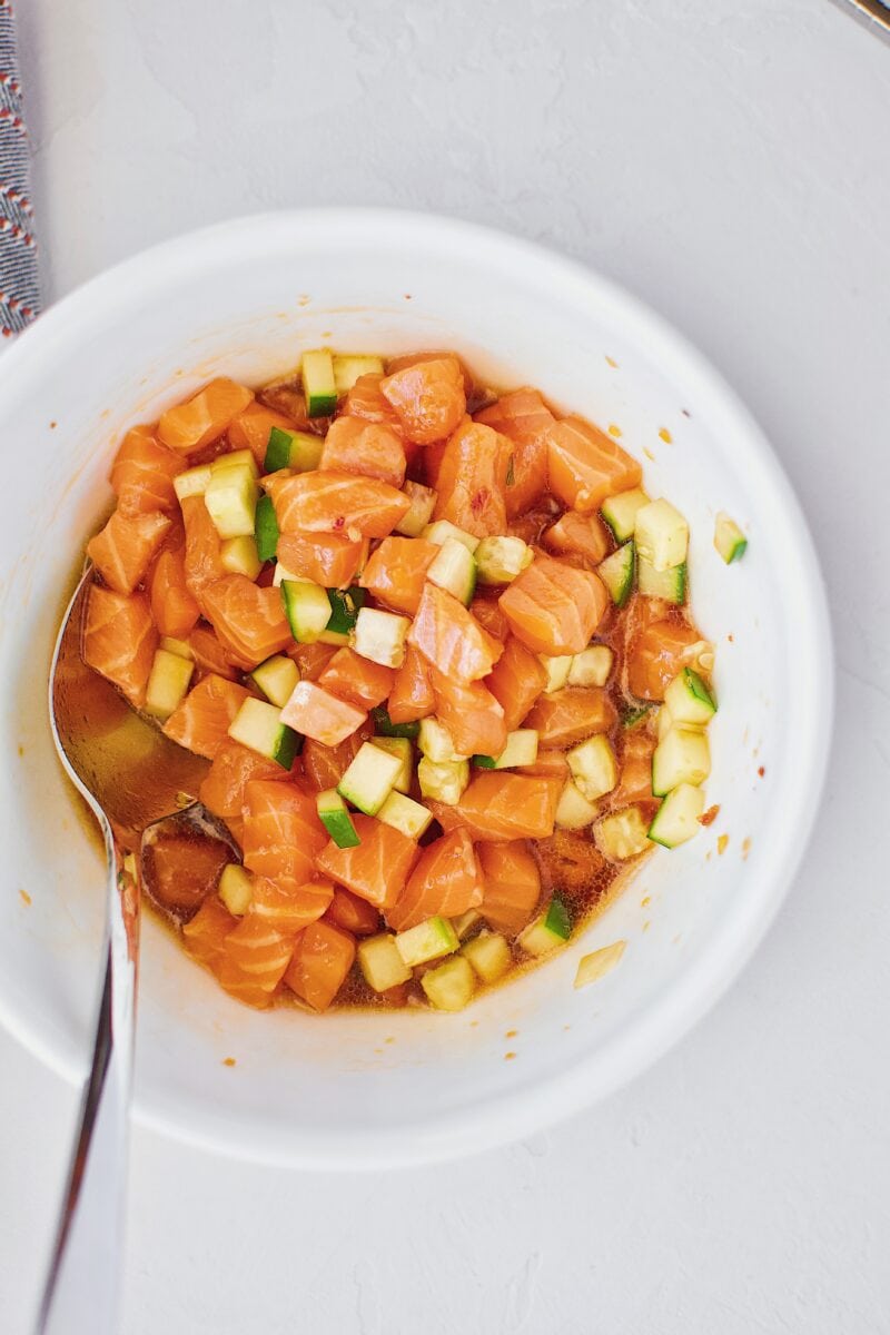 Salmon, cucumber, and poke marinade in a bowl