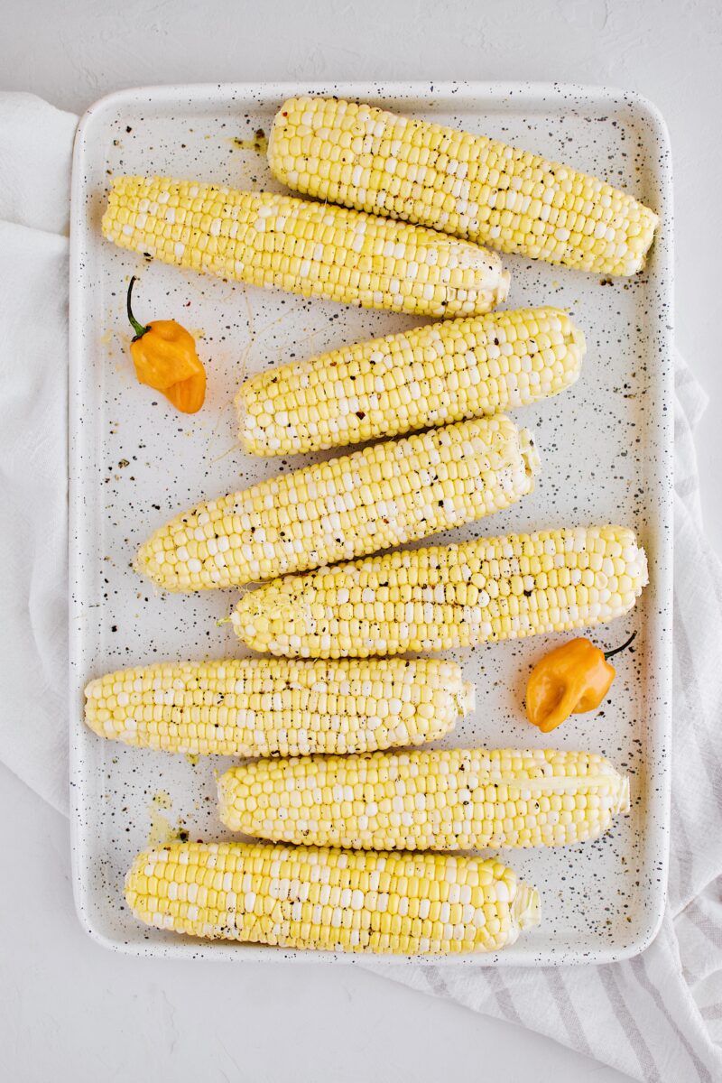 corn ready for the grill, seasoned with oil, salt, and pepper.