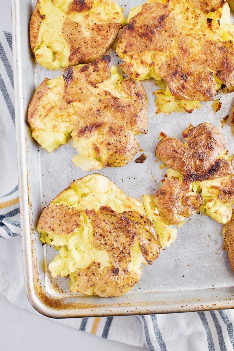 Boiled potatoes that have been smashed and broiled