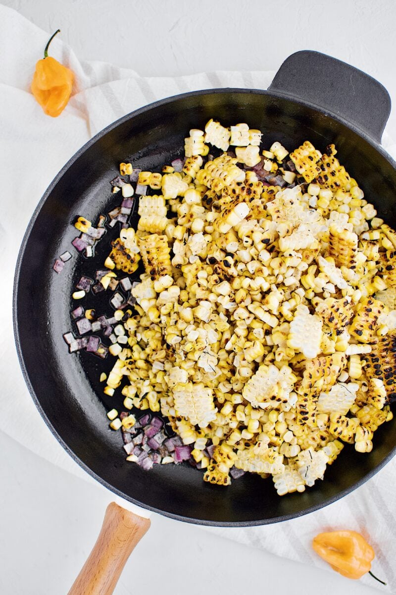 adding in the corn and cooking until warmed