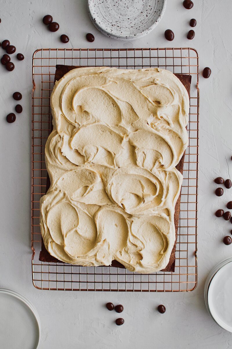 cooled cake with peanut butter frosting spread across the top