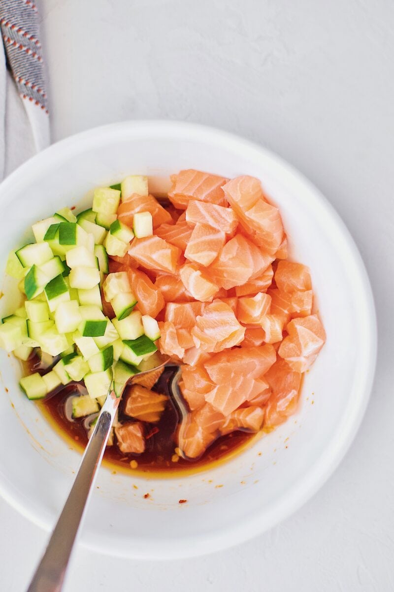 Salmon, cucumber, and poke marinade in a bowl