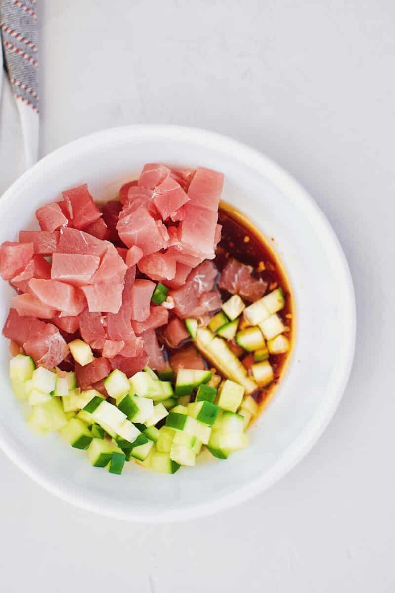 Tuna, cucumber, and poke marinade in a bowl