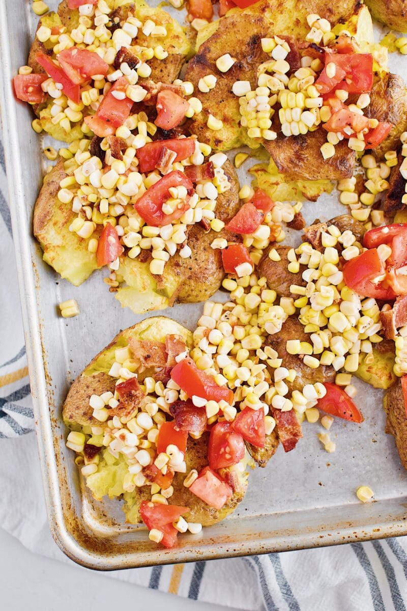 Smashed potatoes with corn salad on top