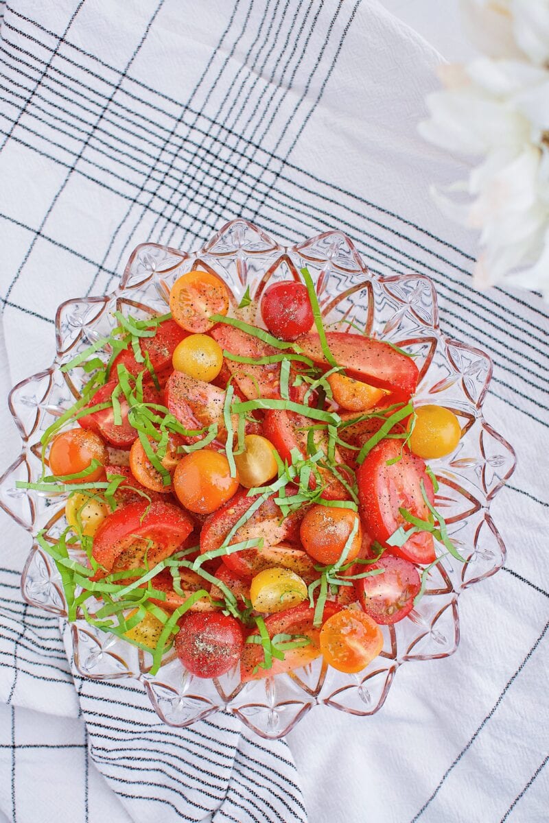 tomatoes marinating and releasing their juices before roasting