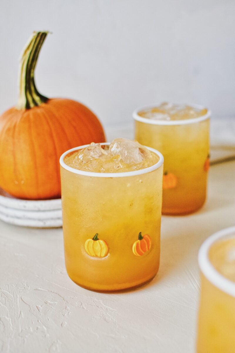 Pumpkin Juice in a pumpkin glass next to a pie pumpkin