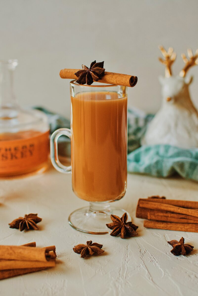 Winter Whiskey Wassail garnished with a cinnamon stick and star anise pod.