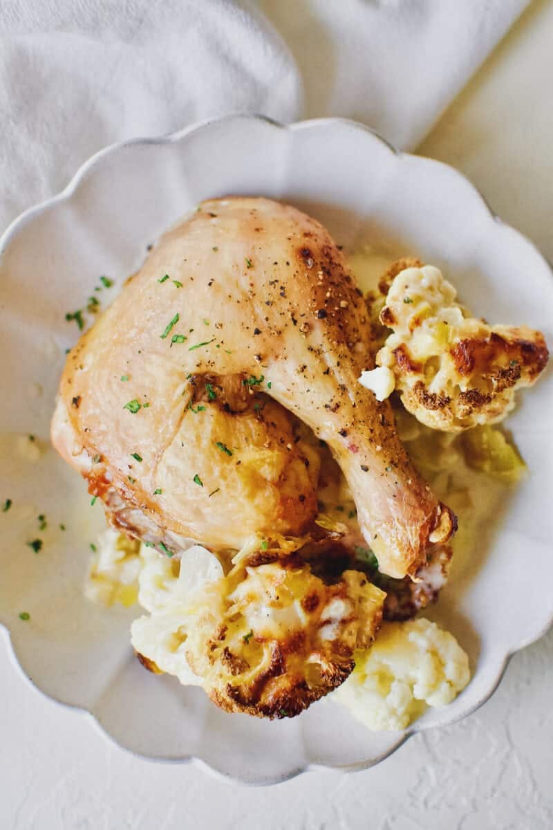 cauliflower and leek gratin served with a piece of roast chicken.