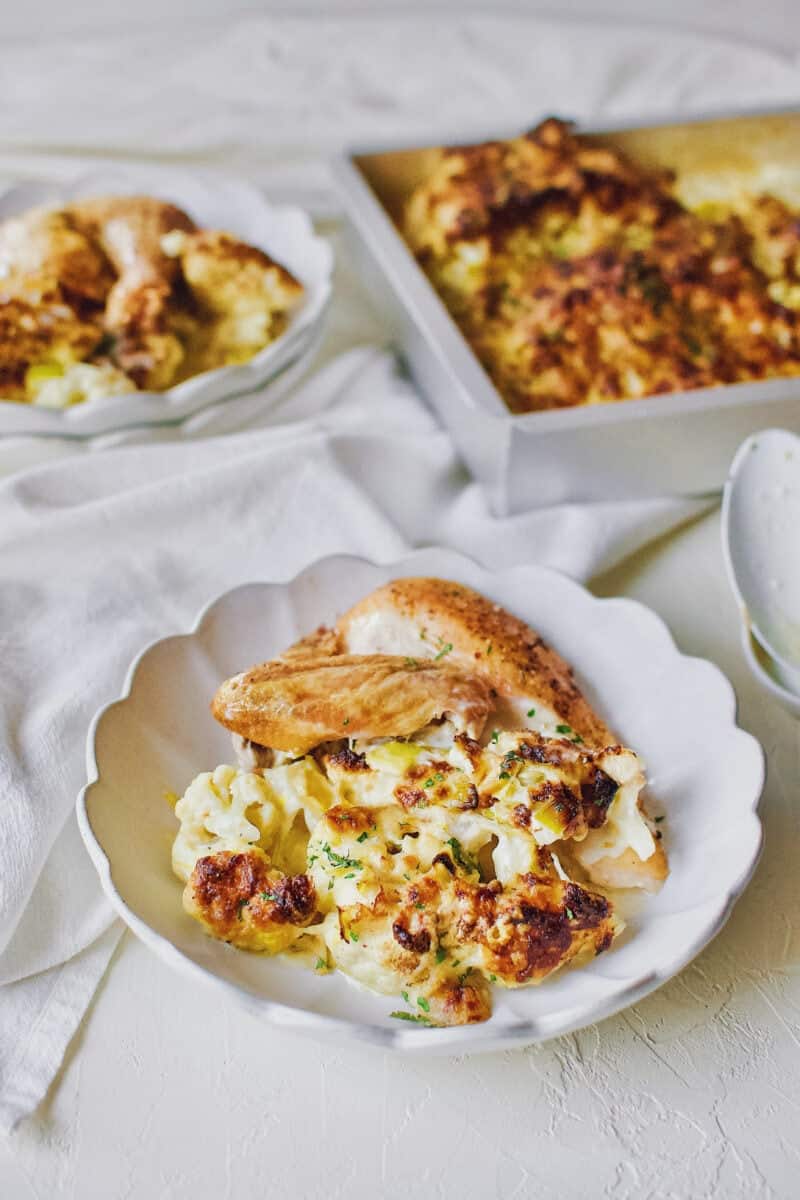 cauliflower and leek gratin served with a piece of roast chicken.