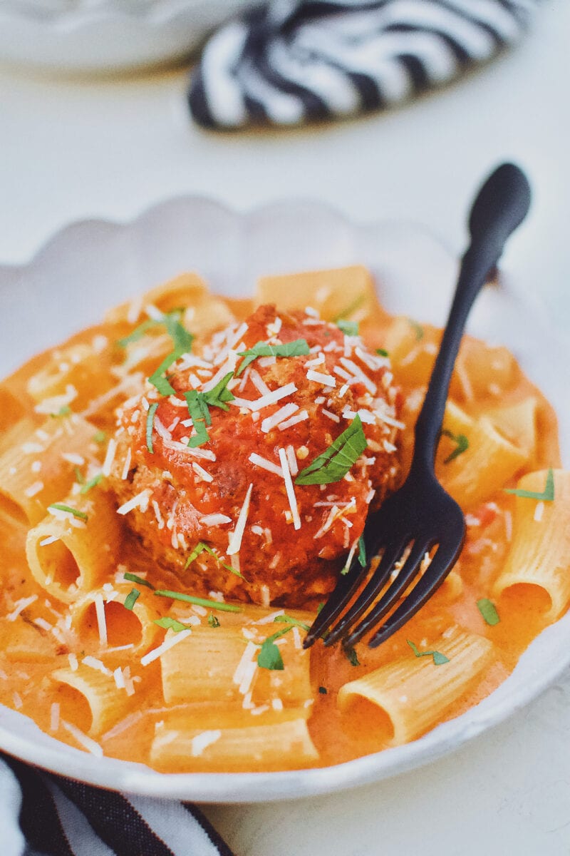 Giant Meatballs in Tomato Sauce served over Rigatoni Pasta and topped with parmesan and parsley.