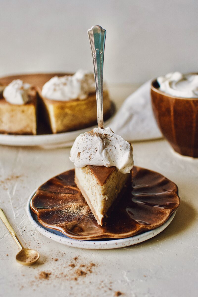 Chai-Spiced Cheesecake ready to eat with a fork pressed into it.