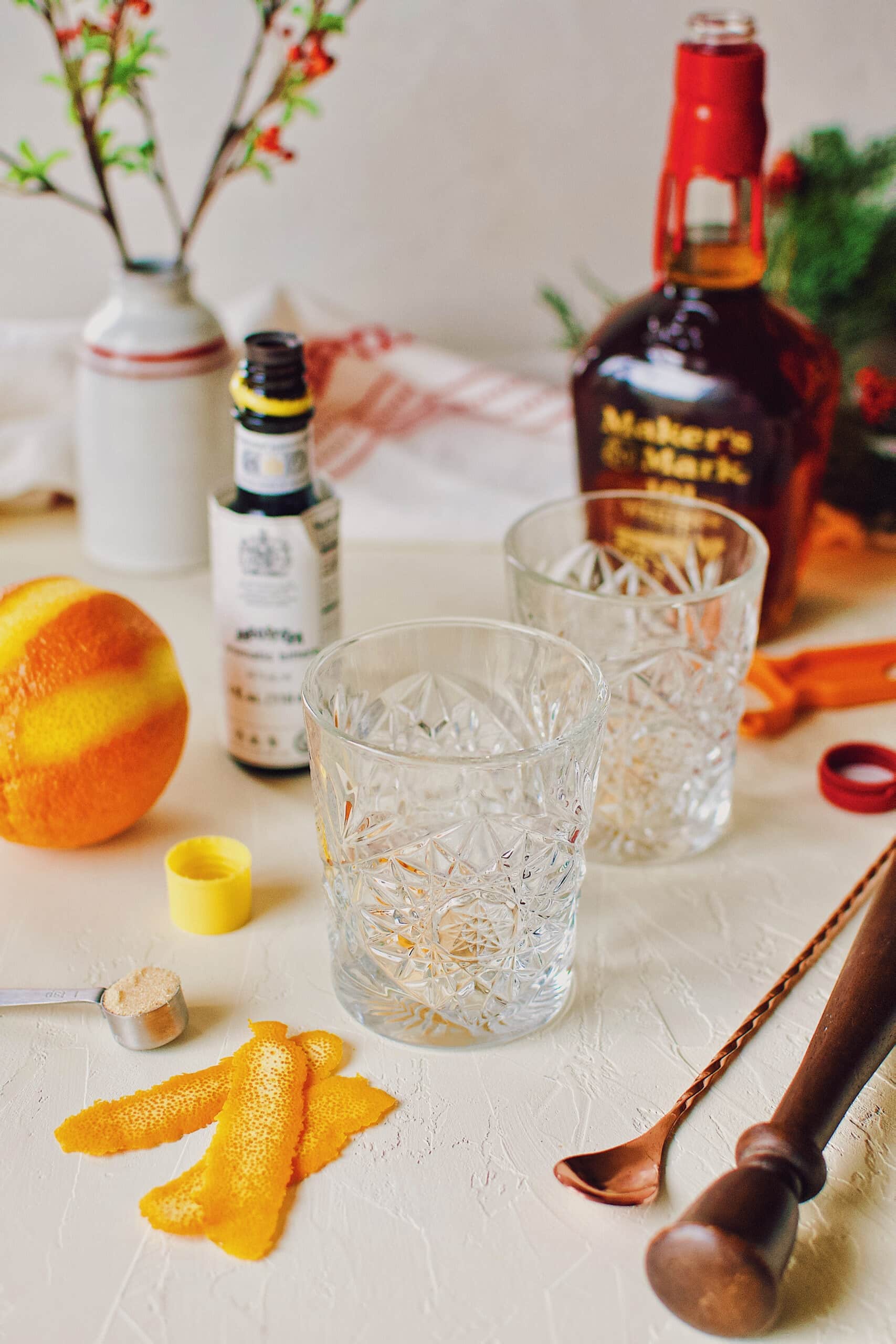 All the ingredients needed to make an old-fashioned sitting around rocks glasses.