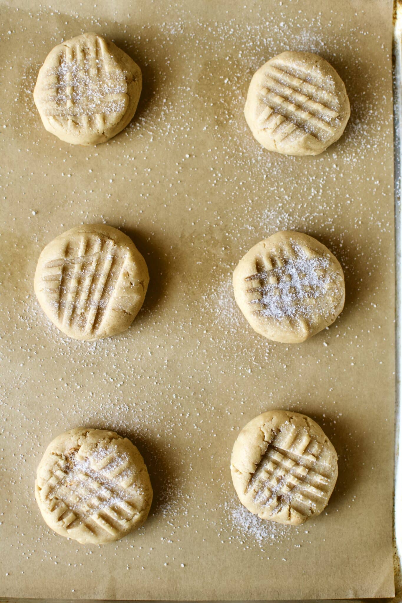 Portioned cookies that have been cross-hatched and ready to be baked.