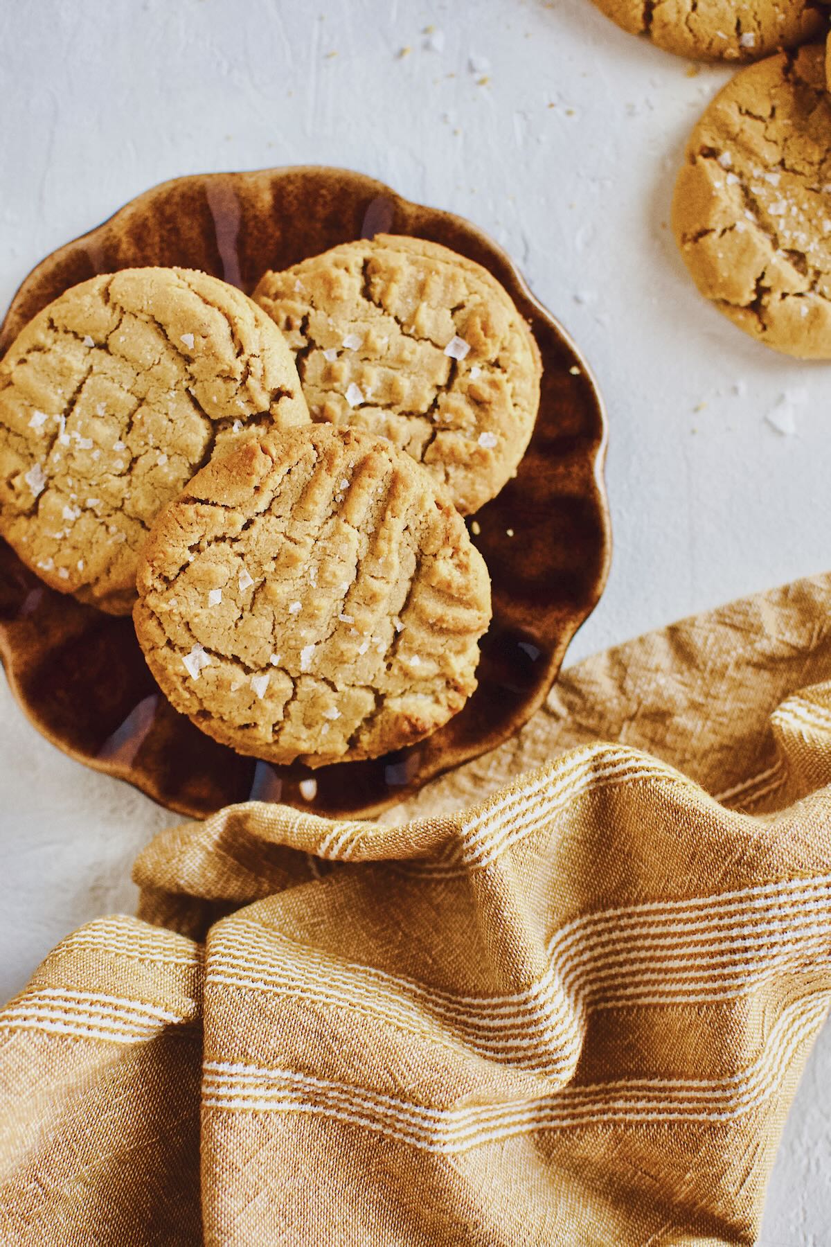 Three Crunchy Peanut Butter Cookies on a plate.