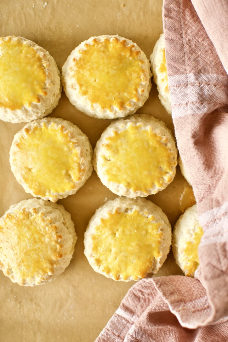 Scones being covered with a tea towel as they cool to steam them.