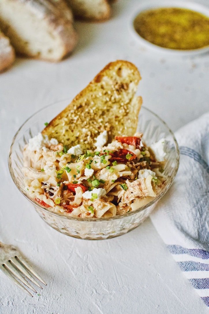 Baked Feta Pasta with Chicken served in bowls with crust bread dipped in olive oil.