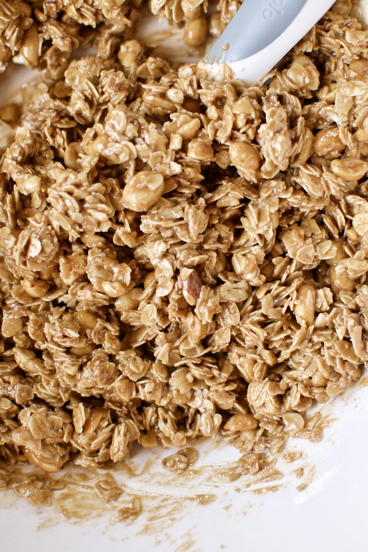 Crunchy Peanut Butter Granola ingredients mixed together in a bowl.