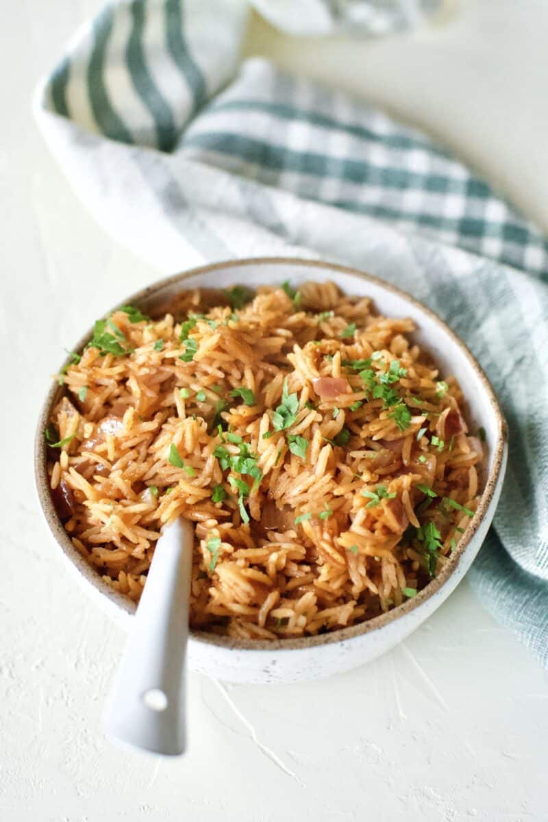 Weta Rice in a serving bowl, topped with Cilantro, and and spoon in the bowl.