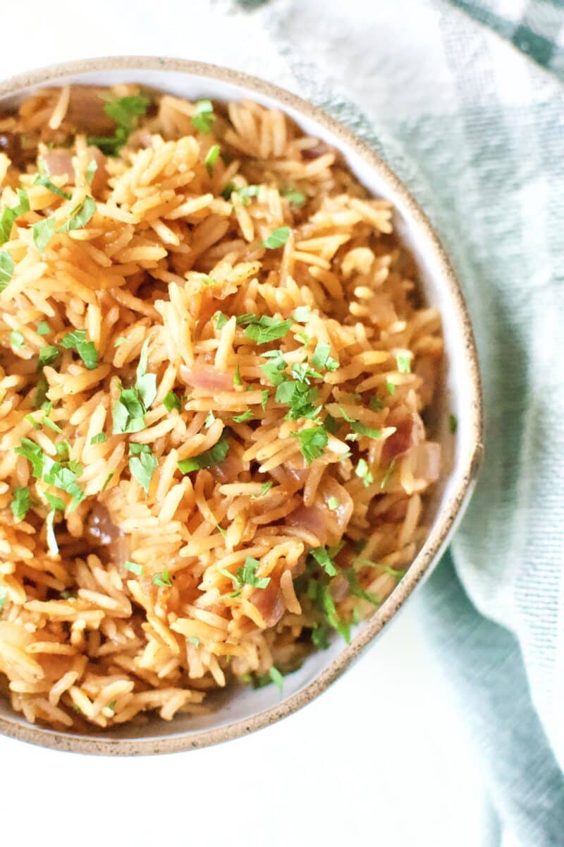 Weta Rice in a serving bowl, topped with Cilantro.